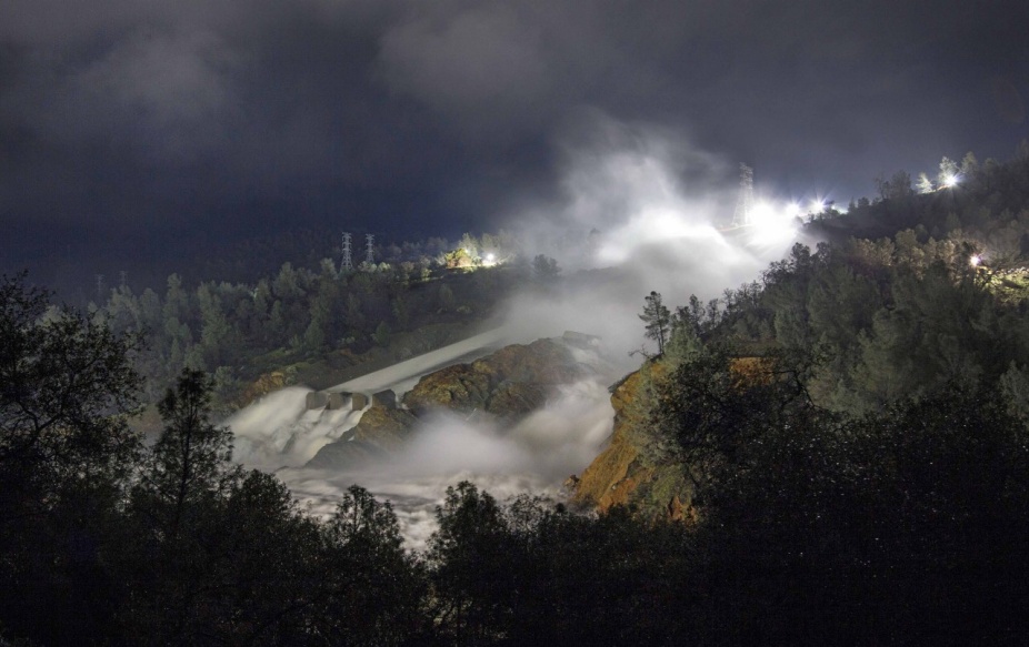 Zoom image: Night-time view of the massive breach of the Oroville Dam, February 2017. Image courtesy of the California Department of Water Resources. 