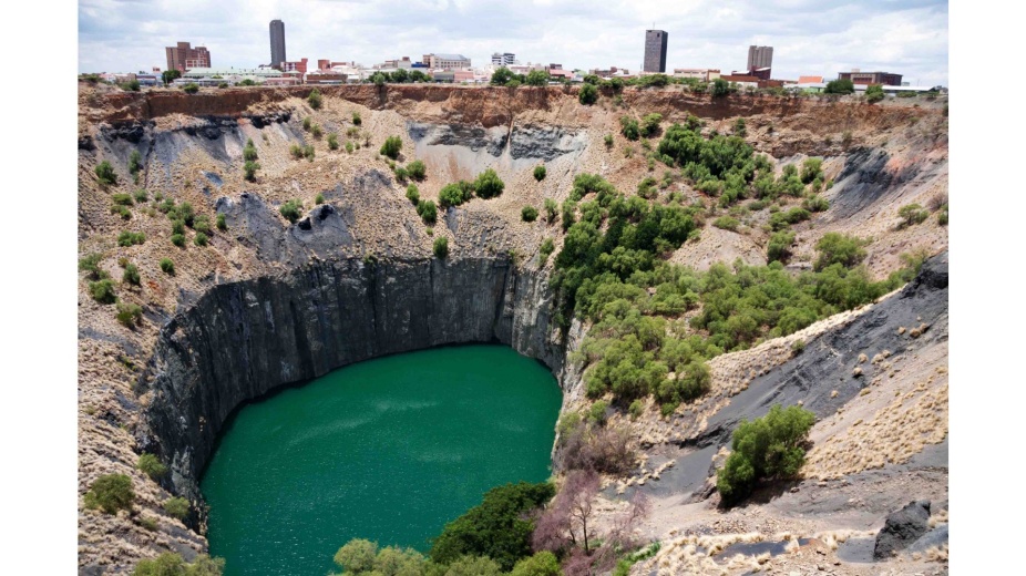 Photograph: Big Hole, Kimberly, South Africa, where the company, De Beers Consolidated Mines Limited, originated in 1888. The mining operations closed in 1914. Today, the site is now a tourist destination supported in part by the company and based on the theme "Diamonds and Destiny". 