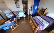 student relaxing in a residence hall. 