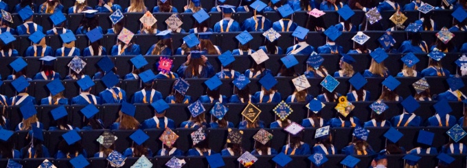 Birdseye view of graduates' caps, many of which are personally decorated. 