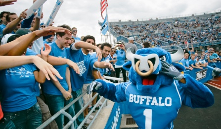 Photo of UB Bulls mascot, Victor E. Bull, with fans. 