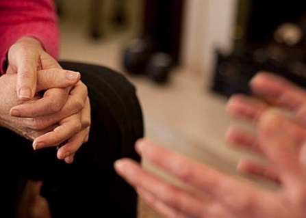 photo of hands of two people in conversation. 