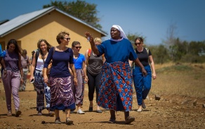 Mara Huber walking with community leader in Tanzania. 