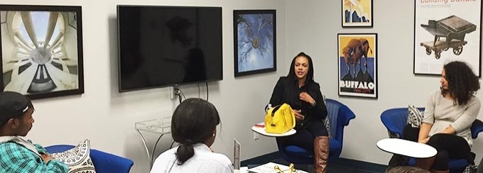 A female entrepreneur speaks to students inside the Blackstone LaunchPad office. 