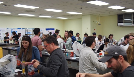 Members of the public learn how to extract DNA in a lab setting. 