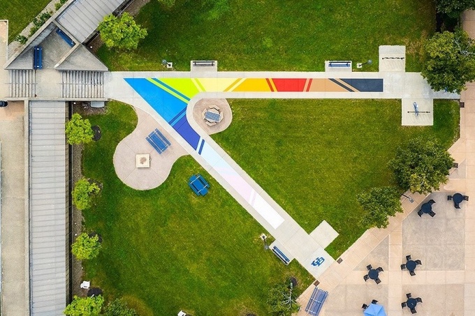 An aerial phot of Progress Pride Paths, a rainbow design including the colors of the Progress Pride flag that is located in Knox Quad outside of the Student Union on UB's North Campus. 