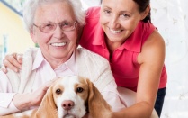 Photo of Older Adult with Young Woman with dog. 