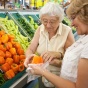 Older adult shopping for produce. 