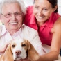 Older Adult woman with caretaker and dog. 