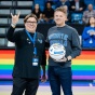 Kelly Cruttenden and Ben Fabian from the LGBTQ FSA on the court at Alumni Arena on Pride Night. 