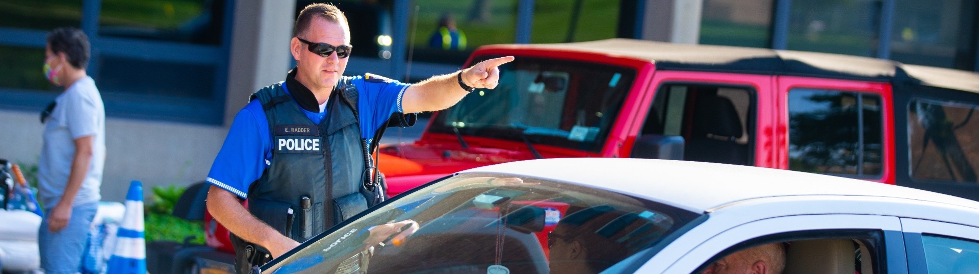 A UB police officer guides drivers during move-in day at the University at Buffalo in 2021. 