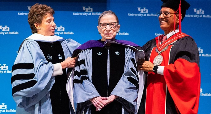 Justice Ruth Bader Ginsburg is hooded by President Satish K. Tripathi and Merryl H. Tisch, chairman of the SUNY Board of Trustees. Photo: Douglas Levere. 