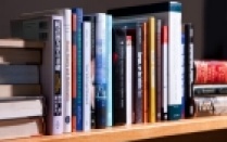 Row of books on a shelf. 