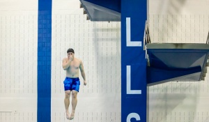 UB Student jumping from the diving platform during Take the Plunge. 