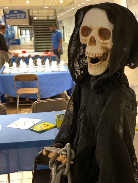 spooky skeleton prop posing in front of various activities during Unplug & Play. 