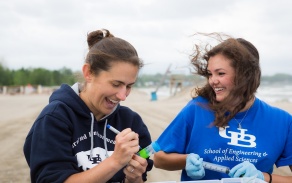 Lauren Sassoubre and Hailie Suk collecting water samples at WoodLawn Beach. 