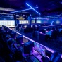 Level Up, the gaming space in Lockwood Library with 50+ gaming computers, is backlit by neon blue and purple lights, creating a galactic feeling gaming space. 