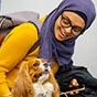 A student with a dog at the end-of-the-semester activities at the Silverman Library as part of the UB Libraries' Stress Relief Days. 