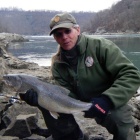 Sandy Geffner, UB adjunct professor of environmental studies, social sciences interdisciplinary, with a catch-and-release lake trout from the Lower Niagara River. 