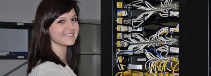 NCS Student in Networking Closet. 