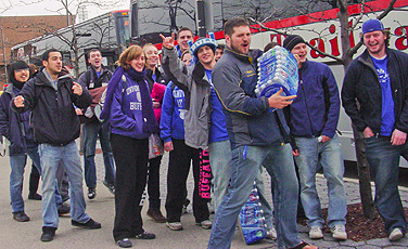 Members of the True Blue student pep club board a bus on Friday for the MAC Championship game in Detroit. Photo: SUE WUETCHER