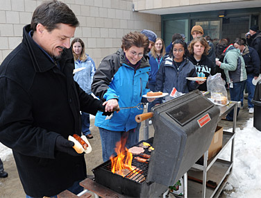 Marcus Bursik mans the grill with the help of Alison Lagowski. Photo: NANCY J. PARISI
