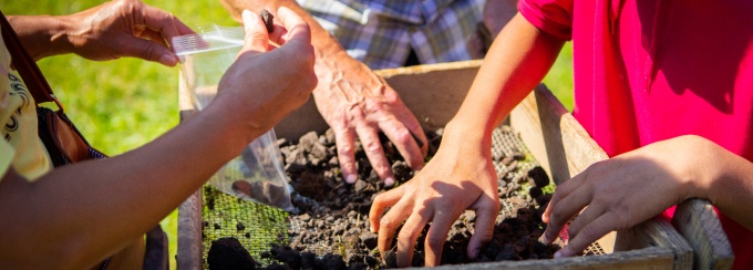 Students sift soil through a screen during an archaeological excavation near Buffalo&rsquo;s Michigan Street Baptist Church, examining artifacts and learning about the site&rsquo;s history. 
