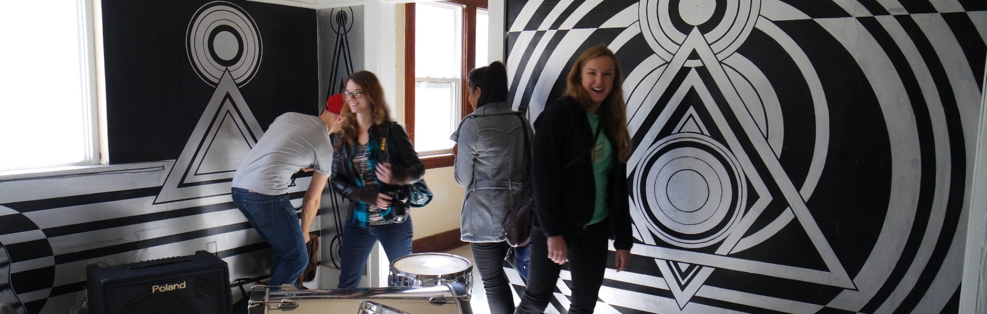 Arts Management students walk through a performance space located in a home in Detroit. 