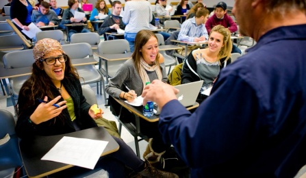 Photo of communication students in a classroom discussion with the professor. 
