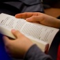 Image of student reading a book on poetics. 