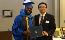 a picture of a UB geography professor Granting award to a student. 