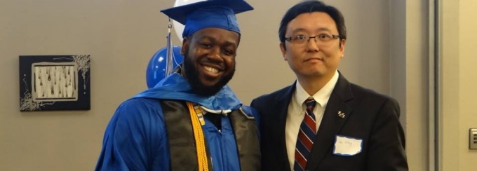 a picture of a UB geography professor Granting award to a student.
