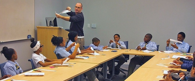 David Hemmer, Chair, UB Department of Mathematics, demonstrates the mysteries of the Mobius strip, for Grade 6 students from Westminster Community Charter School, Buffalo, NY. 