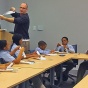 David Hemmer, Chair, UB Department of Mathematics, demonstrates the mysteries of the Mobius strip, for Grade 6 students from Westminster Community Charter School, Buffalo, NY. 