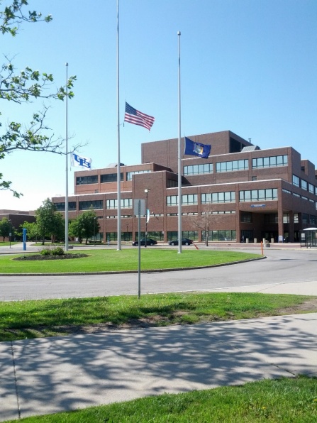 Flags flying at half-staff in front of Capen Hall, UB North Campus. 