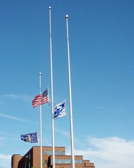 Flags fdlyt at half-staff. 