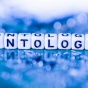 Die on a blue background spells out the word, "ontology.". 