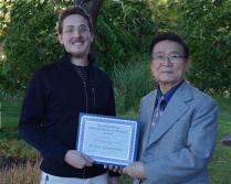 Zoom image: The 2014-2015 Outstanding Teaching/Research Assistant Award was presented to Brian Donahue (left) by UB Philosophy Professor Kah Kyung Cho (right). The award was a tie with Catherine Nolan who is now teaching in Dallas, Texas. 