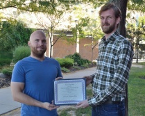 Zoom image: The Hare Award for Outstanding Department Citizenship was presented to John C. Beverley (left) by UB Philosophy Professor Ryan Muldoon (right). 