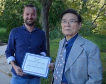 Zoom image: The 2014-2015 Hare Award for Outstanding Graduate Essay (not in ethics) was presented to Rasmus Rosenberg Larsen (left) by UB Philosophy Professor Kah Kyung Cho (right). 