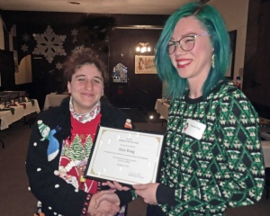 Zoom image: (From left) Angela Menditto, President, UB Graduate Philosophy Association (GPA) present the 2018 Outstanding Faculty Award to Dr. Alexandra King. 