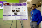 Timothy Semon, winner of the poster competition, showcases his research project, "Assessing the need for orthodontic treatment in the Erie County Poorhouse population." 