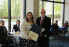 Amandine Eriksen, left, receives the Opler Award for Dissertation Research from Dr. Donald Pollock.