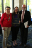 Laura Levon, center, accepts the Dr. Keith F. Otterbein Award in War and Peace for her dissertation research on Northern Ireland and the social consequences of war through a focus on young adults born in the final years of conflict.