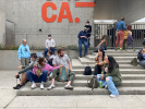 Students in discussion on the steps of the Oakland Museum of California. 