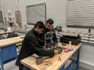Ansih Avasthi and Conor Coster building the 15in cubed robot. 