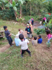 Community member Nelson Picado and EWB’s Evan Supple explain surveying to the children of La Laguna.