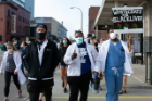 Medical trainees march peacefully down Pearl Street in Buffalo.