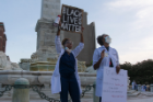 Ashley Jeanlus, MD, right, and LaChaundra Latrice Johnson, MD, left, talk to the marchers.