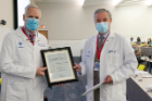Robert N. Sawyer Jr., MD, left, is awarded the Leonard Tow Humanism in Medicine Award by Michael E. Cain, MD, vice president for health sciences and dean of the Jacobs School.